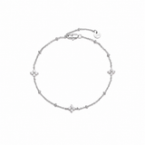 Dainty silver-tone beaded chain bracelet with three cubic zirconia four-petal flower stations, lobster clasp, adjustable extender, and Zoé disc tag.