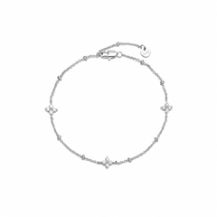 Dainty silver-tone beaded chain bracelet with three cubic zirconia four-petal flower stations, lobster clasp, adjustable extender, and Zoé disc tag.